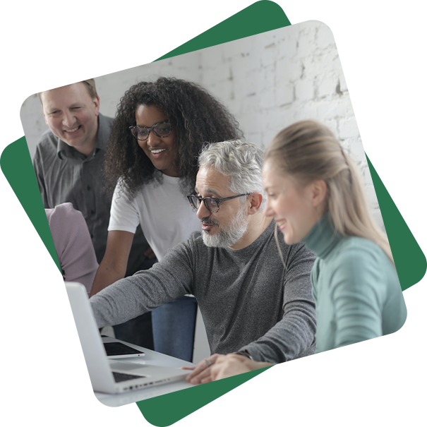 A diverse technology team collaborating around a laptop